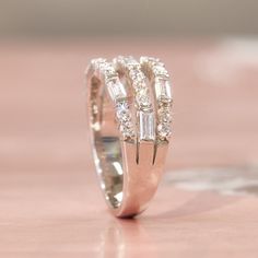 Ring stacking made real easy. Let the Tessa Ring do the work for you with the illusion of stacked rings. 💖 Classy Fashionista's No.1 choice Double Sparkling Everyday Everywhere * 3-layer Heavy Platinum plating over Sterling Silver * Top Grade 5A Cubic Zirconia Diamond Alternatives * Quality that is indistinguishable from a real diamond ring 👍 Recommendations * As a travel wedding band * At parties * When celebrating anniversaries and making a meaningful gift * It's perfect for when you don't want to wear your real diamonds * If you are afraid of damaging or losing your real wedding ring * If you are looking for something more sparkling Features Three rows of brilliant cut round and emerald cut stones are set in an alternating pattern. Tailored shared prongs setting and bar setting allows Luxury Diamond Stackable Rings With Three Stones, Cheap Sterling Silver Stackable Rings For Anniversary, Luxury Diamond Dazzling Stackable Rings, Affordable Sterling Silver Stackable Engagement Rings, Luxury Multi-stone Rings For Anniversary, Luxury Elegant Stackable Rings With Pave Setting, Luxury Platinum Stackable Rings Fine Jewelry, Luxury Three Stone Stackable Rings For Anniversary, Luxury Three Stone Stackable Rings For Women