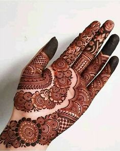 a hand with henna tattoos on it