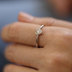 a woman's hand with a diamond ring on it