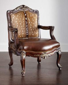 an antique chair with deer hides on it's back and armrests