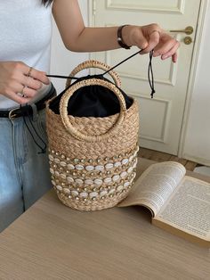 Experience the grandeur of the summertime with the elegantly crafted Elena Handbags Straw Beach Basket. This exquisite basket features intricate detail and durable raffia straw construction, making it the perfect accessory for a stroll on the beach or a sunny picnic. With its timeless appeal, this bag creates a statement of sophistication for any discerning fashionista. Made with raffia strawOpen top with drawstring liningSize: 11"H x 10"W x 5"D Designer Style ID: 8571 Elena Handbags Summer Stra Elegant Summer Straw Bag For Vacation, Elegant Summer Vacation Straw Bag, Handwoven Handheld Beach Bag For Summer, Handwoven Handheld Bucket Bag For Vacation, Chic Summer Bags Made Of Paper Straw, Elegant Crochet Tote Bag For Beach Season, Handheld Handwoven Beach Bag For Summer, Summer Handheld Jute Straw Bag, Summer Handheld Bucket Bag For Beach