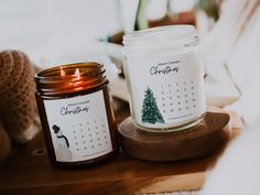 a candle sitting on top of a wooden table next to a teddy bear and calendar