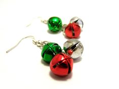 They will hear your holiday spirit coming with these festive handcrafted earrings! Featuring silver, red, and green jingle bells attached to silver chain. These earrings measure 1.25 inches long from base of Sterling silver earring hooks. These earrings come gift wrapped in an eco-friendly box lined with cotton, wrapped with ribbon, ready for giving. Great gift for wife, mom, sister, aunt, friends, co-workers and more! We ship from North Carolina via USPS First Class with free tracking in the Un Diy Christmas Earrings, Jingle All The Way, Jingle Bell, Christmas Earrings, Handcrafted Earrings, Earring Hooks, For Sale Sign, Silver Earring, Jingle Bells