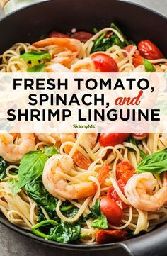 fresh tomato, spinach and shrimp linguine pasta in a skillet