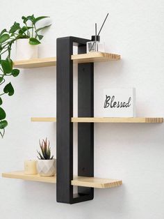 three wooden shelves on the wall with plants in them and a sign that says blessing