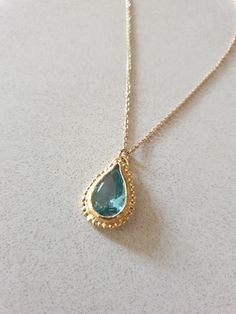 This 14k gold filled Blue Topaz necklace was designed in an antique style, with a bright Turquoise colored pendant in a teardrop shape. The gemstone birthstone necklace is handmade and delicate and available both in 14 karat gold filled and sterling silver. The Blue Topaz is lab made. Dimensions: Pendant height is 0.5 inches and it is 0.3 inches wide. This pendant necklace is available in multiple lengths. Please choose on checkout. The Blue necklace is a great birthstone necklace for mom and th Elegant Turquoise Teardrop Pendant Drop Necklace, Gold Drop Necklace With Birthstone Teardrop Pendant, Gold Teardrop Pendant Necklace With Birthstone, Handmade Gold Teardrop Drop Necklace, Gold Drop Birthstone Necklace With Gemstone, Gold Drop Necklace With Birthstone, Gold Birthstone Drop Necklace, Gold Pear-shaped Drop Necklace With Gemstone, 14k Gold Teardrop Birthstone Necklace