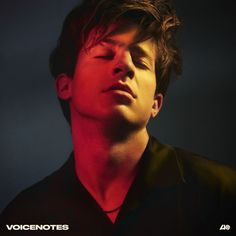 a young man with his eyes closed in front of a dark background and the words voicentotes deluxe above him