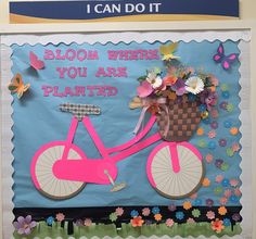 a bulletin board with a pink bicycle and flowers on it that says, bloom where you are planted