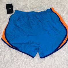 Nike Womens Dri Fit Running Shorts In Blue And Orange Size Small New With Tags And Liner Blue Color Block Bottoms For Beach, Nike Multicolor Sports Bottoms, Nike Casual Multicolor Bottoms, Casual Multicolor Nike Bottoms, Casual Color Block Workout Bottoms, Nike Multicolor Casual Bottoms, Casual Gym Shorts With Color Block, Orange Athleisure Bottoms For The Beach, Casual Orange Athletic Shorts For Workout