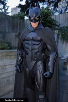 a man in a batman costume standing outside