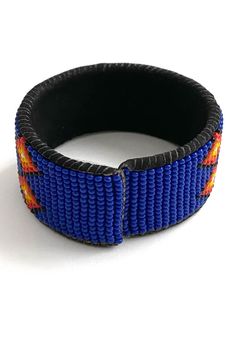 A beaded cuff from Guatemala with cobalt blue, red, orange, yellow, white & black colored seed beads. This beautiful patterned cuff is lined with black suede. Details: Beaded Cuff from Guatemala Cobalt blue, red, orange, yellow, white, & black seed beads Lined with black suede 1" cuff width Made in Guatemala. Artisan Blue Cuff Bracelet, Blue Cuff Bracelet For Festivals, Blue Cuff Bracelets For Festivals, Blue Cuff Bracelet For Festival, Artisan Blue Cuff Bracelet For Festivals, Traditional Blue Adjustable Cuff Bracelet, Blue Beaded Bracelet With Black Beads For Festival, Adjustable Beaded Blue Cuff Bracelet, Adjustable Blue Beaded Cuff Bracelet