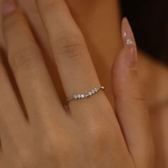 a woman's hand with a diamond ring on it