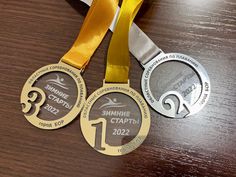 two medals on a table with ribbons around them and the numbers 1, 2, 3, 4