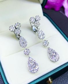 HANDCRAFTED TO PERFECTION! SPECIAL AND LOVELY TEARDROP DESIGN, ILLUSION SETTING (APPEARS TO BE LIKE A 1-2 CARAT BRILLIANT PEAR Diamonds). With over 104 pieces of UNTREATED AND GENUINE F/VS QUALITY SPARKLING DIAMONDS! Perfect for every event! SET IN 18K SOLID WHITE GOLD HANDCRAFTED, DANGLING EARRINGS! SUGGESTED RETAIL VALUE: $9,000 DIAMONDS: 104 ROUND BRILLIANT, FULL CUT with excellent firing diamonds, weighting at 3.14 carats. ALL NATURAL, UNTREATED DIAMONDS. ALL DIAMONDS HAVE NO VISIBLE INCLUSI Elegant Brilliant Cut Clip-on Earrings For Wedding, Fine Jewelry Bridal Drop Earrings With Diamond Accents, Diamond Drop Bridal Earrings, White Gold Teardrop Chandelier Earrings Fine Jewelry, White Gold Teardrop Chandelier Earrings, Silver Luxury Clip-on Diamond Earrings, Luxury White Gold Chandelier Earrings Pear-shaped, Elegant White Gold Pear-shaped Chandelier Earrings, White Gold Drop Bridal Earrings For Formal Events