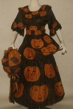 a woman's dress with pumpkins on it