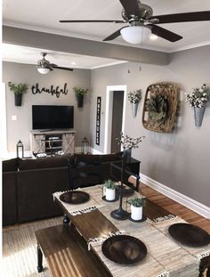 a living room filled with furniture and a flat screen tv mounted to the side of a wall