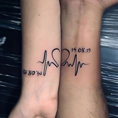 two people with matching tattoos on their arms, one has a heart and the other has a heartbeat