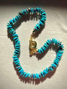 Experience the allure of genuine, untreated, and undyed natural Arizona Turquoise with our luxurious beaded necklace. This stunning piece features 10mm heishi-shaped turquoise beads, meticulously hand-knotted on vibrant purple silk thread to ensure both beauty and durability. Each bead is separated by a secure knot, enhancing the necklace's flexibility and longevity while providing a striking visual contrast. Accented with shimmering gold-filled beads and finished with a sturdy gold-filled lobst Turquoise Amazonite Necklace With Round Beads, Artisan Turquoise Amazonite Necklace, Turquoise Rondelle Beaded Gemstone Necklaces, Turquoise Gemstone Necklace With Round Beads, Artisan Hand-strung Turquoise Necklace Gift, Rondelle Turquoise Necklace With Natural Stones As Gift, Turquoise Rondelle Necklaces With Natural Stones, Turquoise Rondelle Necklace With Natural Stones For Gifts, Turquoise Natural Stones Rondelle Necklace