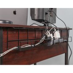 an apple computer is hooked up to the wall with wires and plugs in it