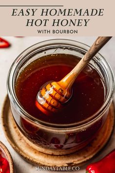 homemade hot honey in a glass jar with a wooden spoon on top and the title overlay reads easy homemade hot honey with bourbon