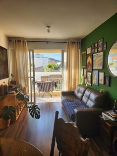 a living room filled with furniture and green walls