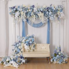 a couch sitting under a blue and white floral arch