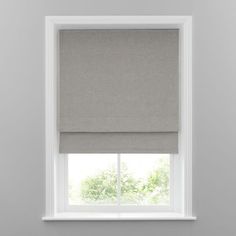 a grey roman blind in front of a window