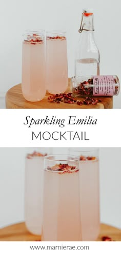 three glasses filled with pink liquid sitting on top of a wooden table next to a bottle