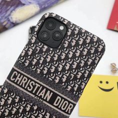 an iphone case with the words christian dor printed on it next to other items