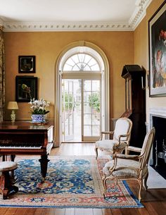 a living room filled with furniture and a piano