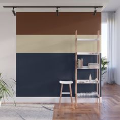 a living room with blue and white striped walls, wooden flooring and a book shelf