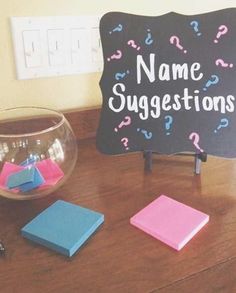 a blackboard that says name suggestions next to some sticky notes and a glass bowl