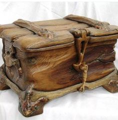 a wooden box sitting on top of a white sheet