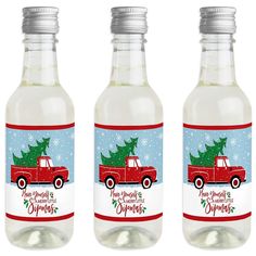 three bottles of water with a christmas tree on the top and snowflakes in the bottom