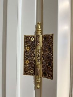 an ornate door handle on the side of a white door