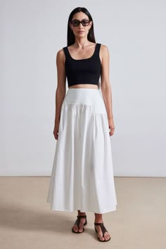 100% Organic Cotton Made in India Full, a-line skirt, zipper closure at the left side, fitted waist, asymmetrical shape Hand wash cold, lay flat to dry, or dry clean Measurements from size S. Length: 35 1/2" Fits true to size. Select your usual size Model is 5'10 and wearing a size 4 White Asymmetrical Skirt, Tier Skirt Outfit, Aline Skirts, Full Skirt Outfit, Asymetric Skirt, A Line Skirt Outfits, Closet Build, Modern Skirt, White Cotton Skirt