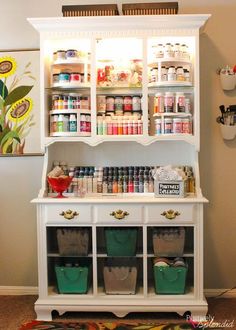 a white cabinet filled with lots of bottles