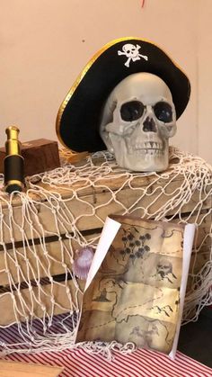 a skeleton wearing a pirate hat sitting in a hammock with other items around it