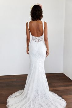 a woman in a white wedding dress looking back