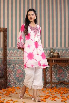 Indulge in elegance with our Pink Tie And Dye Suit Set. The beautiful pink hue and handwork make it the perfect statement piece for any occasion. Crafted from luxurious organza, the delicate tassels add a touch of charm to this unique and sophisticated ensemble. Elevate your wardrobe with this exclusive piece. No. of pieces - 2 piece set. Color - Pink. Kurta Fabric - Organza. Washing Instructions - Dry Clean. Long Sleeve Pink Kurta With Gota Work, Pink Semi-stitched Handwork Kurta, Pink Straight Kurta Set With Dori Work, Pink Straight Kurta Set With Mirror Work, Pink Summer Sets With Mirror Work, Pink Dori Work Kurta For Party, Festive Pink Kurta With Handwork, Pink Dabka Work Kurta For Celebration, Pink Sets With Resham Embroidery For Spring