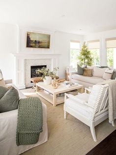 a living room filled with furniture and a fire place in the middle of a room