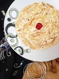 a white plate topped with a cake covered in lots of toppings next to bracelets