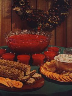 a table topped with plates of food and bowls of dips next to each other