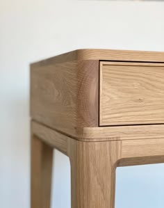 a close up of a wooden table with drawers