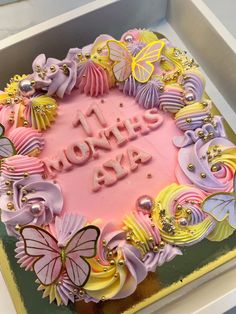 a birthday cake decorated with butterflies and the words i love you in pink frosting