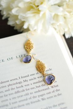 "Purple and Gold Earrings. Stunning faceted purple glass stones are suspended from beautiful matte gold ornate filigree connectors and gold plated hook ear wires. The total length of these earrings is approx. 1.8\" (46mm). Purple glass measures 12mmx 17mm If you prefer the glass stones in a different color, please feel free to contact me. ♥ Click here to see more earrings: www.etsy.com/shop/LeChaim?section_id=17655958 ♥ My shop: www.etsy.com/shop/LeChaim ♥ About LeChaim: www.etsy.com/shop/LeChai Jewelry Bridesmaid, Earrings Purple, Purple Earrings, Amethyst Purple, Drop Dangle Earrings, Purple Glass, Purple Wedding, Bridesmaid Earrings, Matte Gold