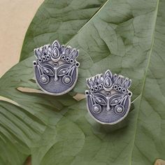 Elevate your style with these exquisite Oxidized Durga Stud Earrings, a perfect blend of artistry and spirituality. Each pair of these stud earrings is meticulously handcrafted to capture the essence of Goddess Durga, the embodiment of strength, courage, and protection. 🌟 Key Features: ✨ Intricate Oxidized Finish: These earrings are meticulously treated with an oxidized finish, creating an antique and timeless look that adds character to your attire. ✨ Durga Inspired Design: The design of these Silver Jewelry With Artistic Design For Festive Occasions, Festive Silver Jewelry With Artistic Design, Traditional Wedding Earrings With Artistic Design, Traditional Earrings With Artistic Design For Festivals, Artistic Jewelry With Artistic Design For Festivals, Traditional Artistic Design Earrings For Festivals, Oxidized Finish Earrings For Rituals And Festivals, Traditional Earrings With Oxidized Finish, Traditional Earrings With Oxidized Finish And Adjustable