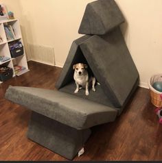 a small dog sitting in a chair made to look like it's been built into the floor