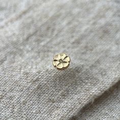 This beautiful 9ct gold flower stud is made up of a bright yellow natural diamond which is just 1mm across.  A perfect earring to sit in a curated ear look. Bringing some warm yellow gold to any look.   The earring itself is made out of solid 9ct yellow gold and is attached from behind the lobe with a screw ball back.  The gap between the front and the screw ball back is 5mm.  One single earring.   This ear stud was hand made by myself in my workshop in Surrey, England.  If you require more of t Yellow Gold Flower Earrings, 14k Yellow Gold Round Flower Earrings, Yellow Gold 14k Round Flower Earrings, Gold Round Flower Earrings In 14k Gold, Gold Flower Earrings In 14k Round Shape, 14k Gold Round Flower Earrings, Gold Birth Flower Round Earrings, Tiny Yellow Gold Round Nose Studs, Gold Round Birth Flower Earrings