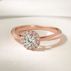 a rose gold engagement ring with an oval diamond center